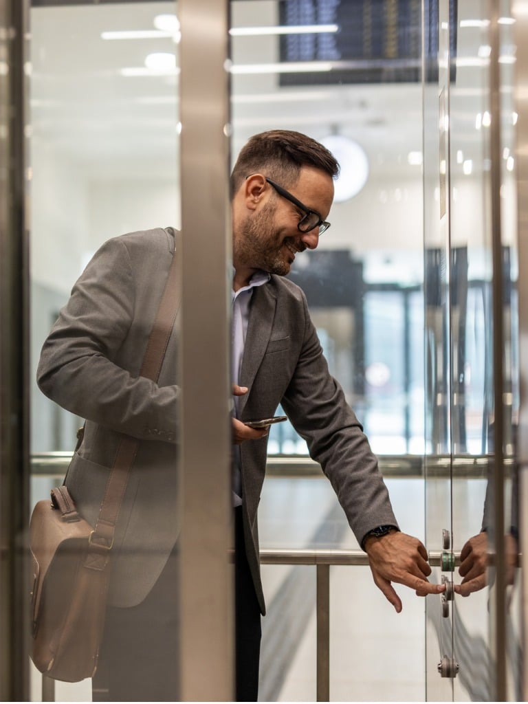 Business Man Pushing Elevator Buttons