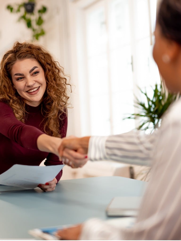 Smiling women greeting Colleague during a meeting
